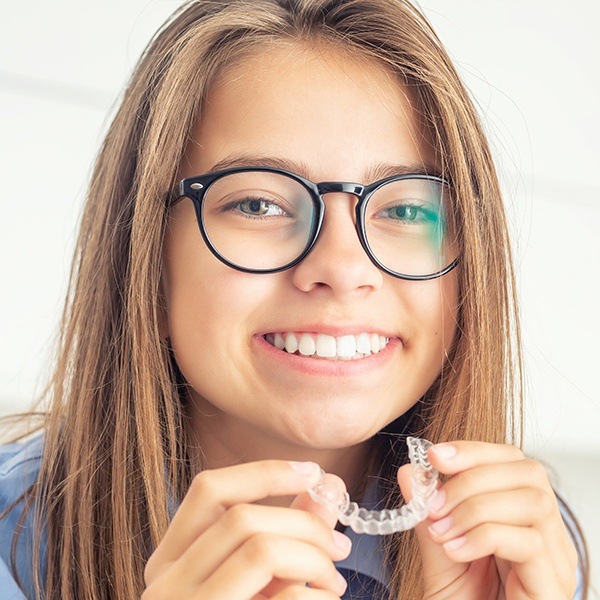 Young woman placing invisalign tray