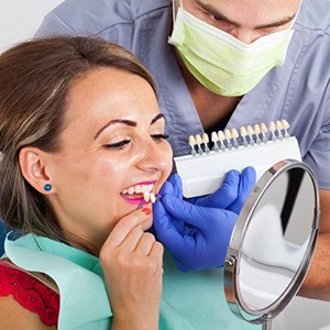woman in dental chair previewing her smile with veneers 