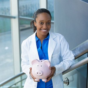 cosmetic dentist holding a pink piggy bank 