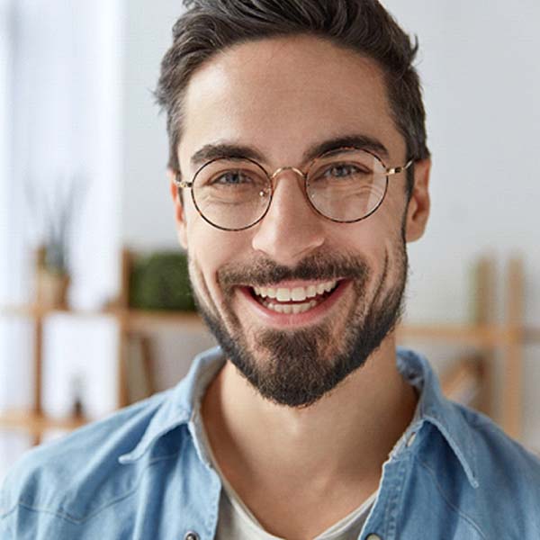 Man with a dental bridge smiling