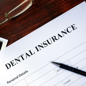 Dental insurance form with glasses and X-rays