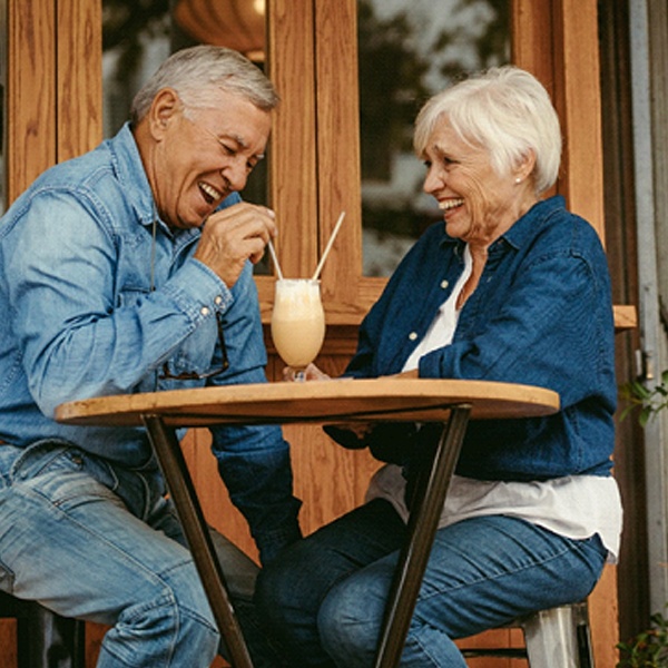 Senior couple sharing milkshake with dentures in Virginia Beach