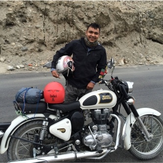 Doctor Goyal standing next to motorcycle