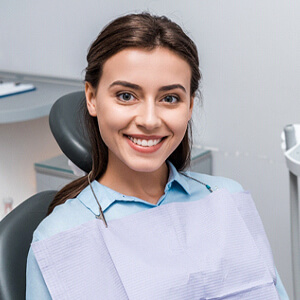 Woman visiting dentist to prevent dental emergency in Virginia Beach, VA