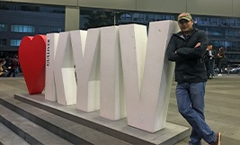 Dotor Goyal next to a Kyiv sign